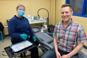 Man sitting with dental hygenist