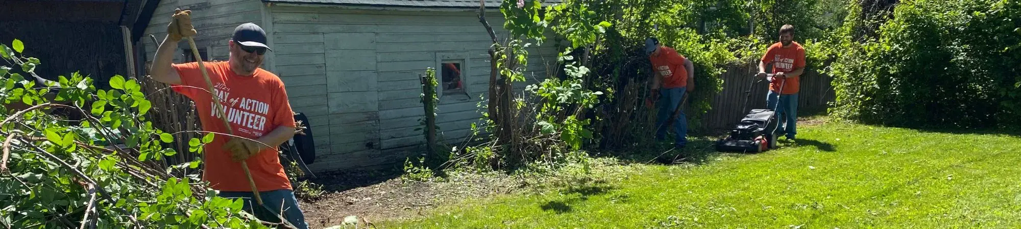 Day of Action volunteers clean up a Keewatin resident's yard